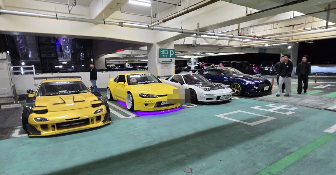 Cars lined up at a Japanese car meet; visible license plate obscured